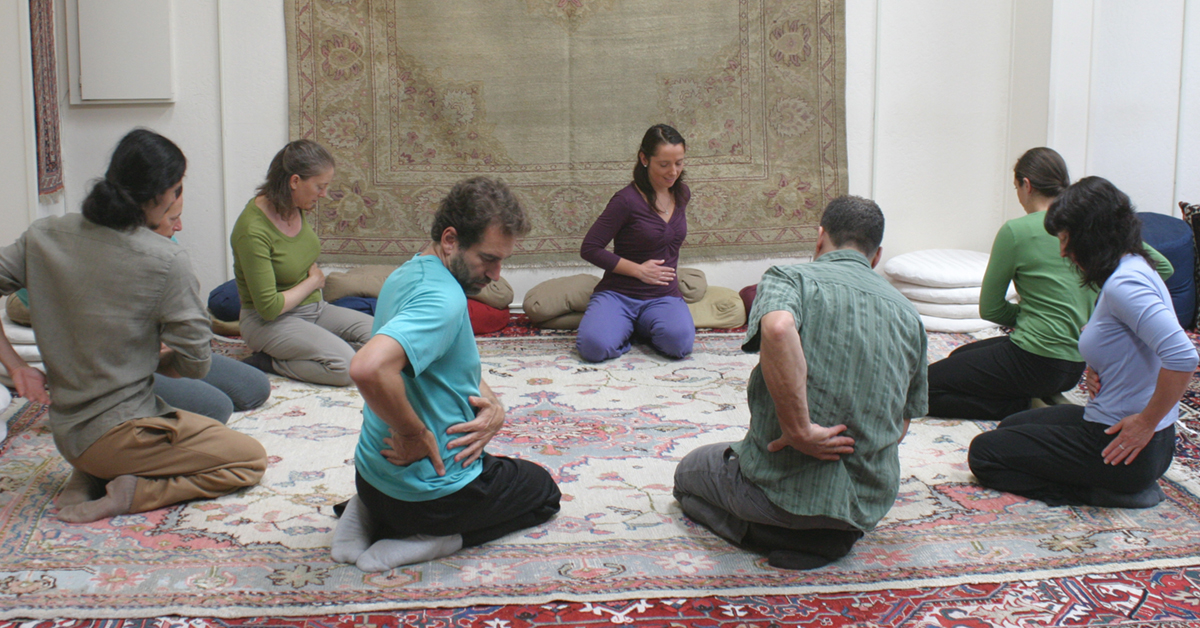 Students practicing self-care exercises in a Self-Breema class