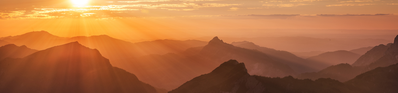 Sun rays layering the Austrian mountain alps.