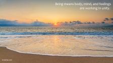 Sun sets on a cloudy horizon while the tide comes in on a reflective beach.