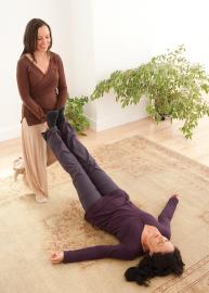 Smiling woman practicing Breema bodywork