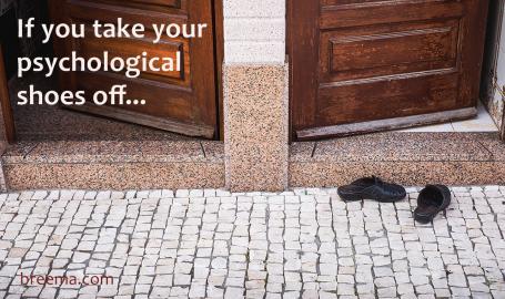 Two open doors with a pair of shoes in front of one of them