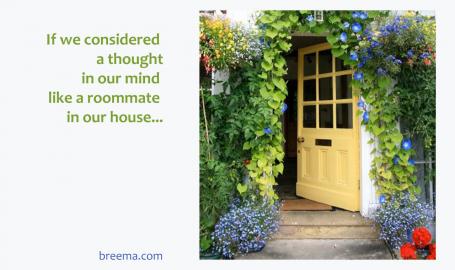 Yellow glass door open on a porch surrounded by vines and flowers 