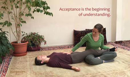 Ariadne Thompson practicing Breema bodywork with a woman lying on the floor