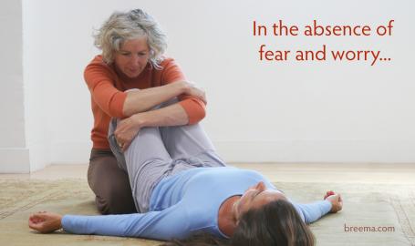 Woman practicing a Breema bodywork sequence