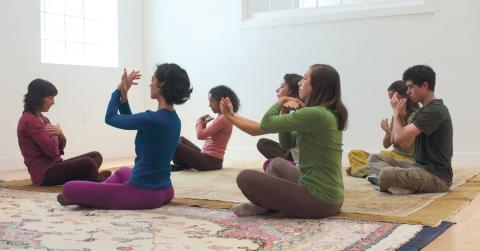 Students practicing self-care exercises in a Self-Breema class