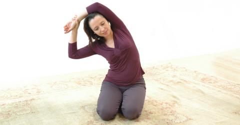 Salena Irion practicing Self-Breema exercises on the floor