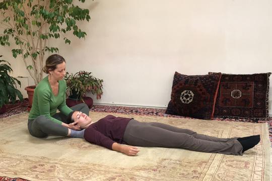 Ariadne Thompson practices Breema bodywork with a Breema student