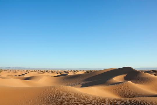 Desert dunes and blue sky