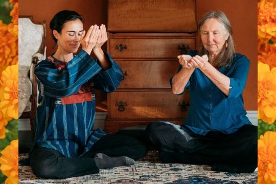 Alexis & Birthe raising cupped hands side by side